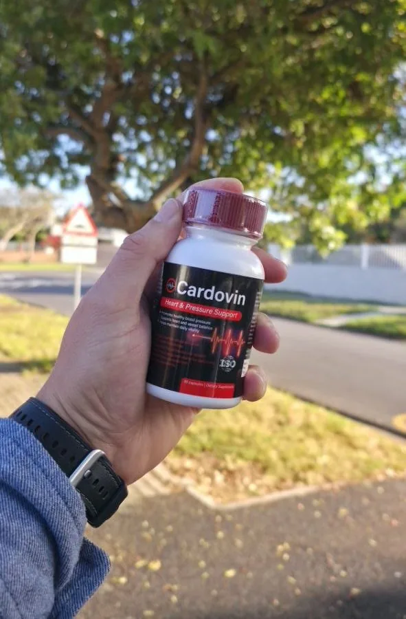 Cardovin bottle held outdoors on a street